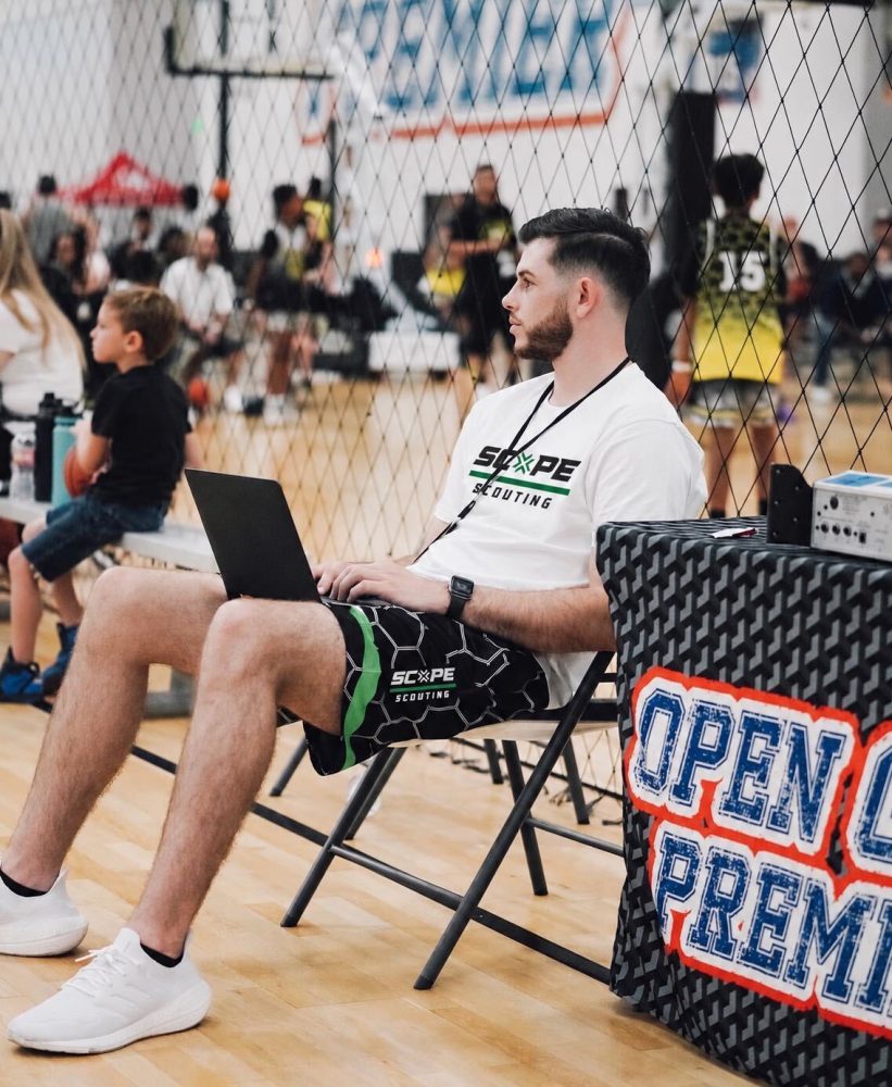 Scope Scouting evaluator courtside with a laptop